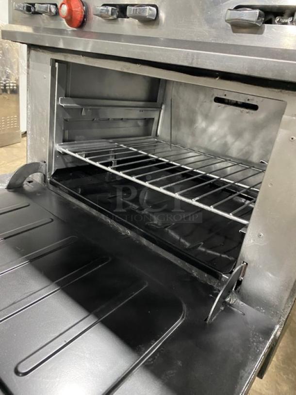 Vulcan commercial stainless steel 6-burner range/oven combo with wired rack, backsplash, and salamander shelf in good condition.