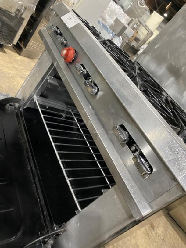 Vulcan commercial stainless steel gas range/oven combo with 6 burners, backsplash, overhead salamander shelf, and wired oven rack.
