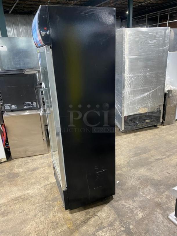 Dukers LG430F merchandiser refrigerator with black single glass swing door and poly-coated rack, 115V, on legs, side view.