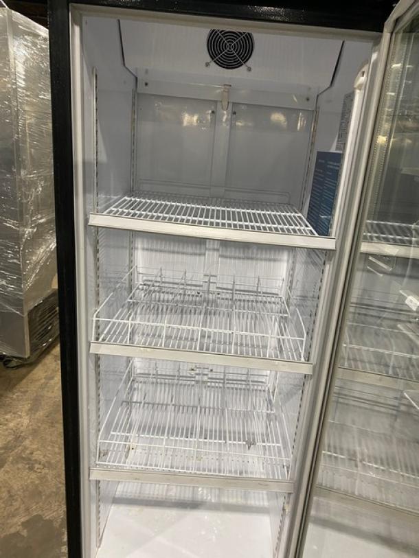 Dukers LG430F commercial refrigerator with single glass swing door, poly-coated wire shelves, black frame, 115V, on legs.