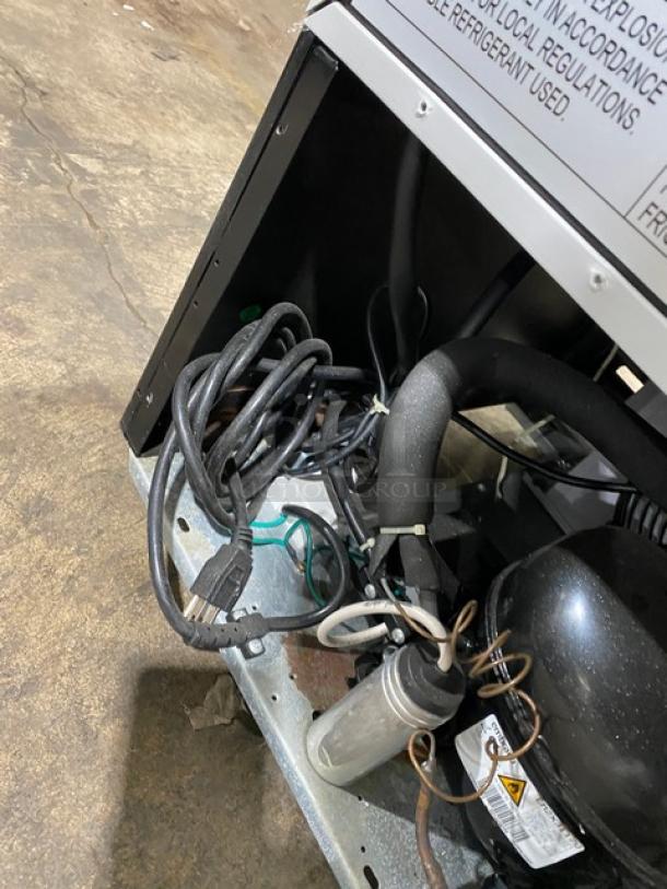 Dukers LG-430F commercial refrigerator back view, showing electrical wiring and compressor.