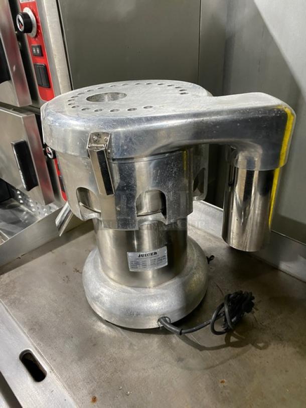 L&J WFA2000 stainless steel electric juice extractor, countertop model, 110V, good condition, visible power cord attached.