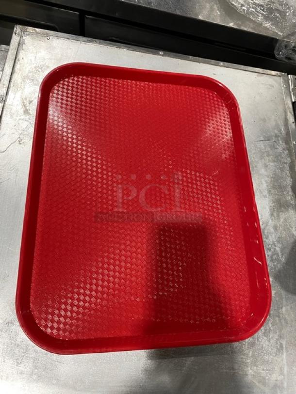 Red Cambro 14"x18" serving tray, model 1418FF163, in new condition. Rectangular with textured surface.