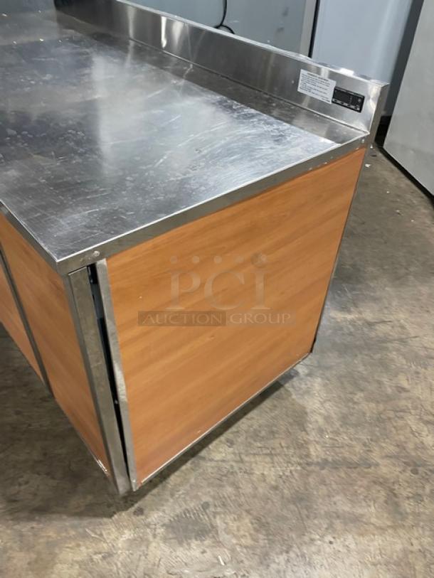 Duke Commercial Stainless Steel 2-Door Worktop Refrigerator, Model RBC60M, with up-turned backsplash, on legs.