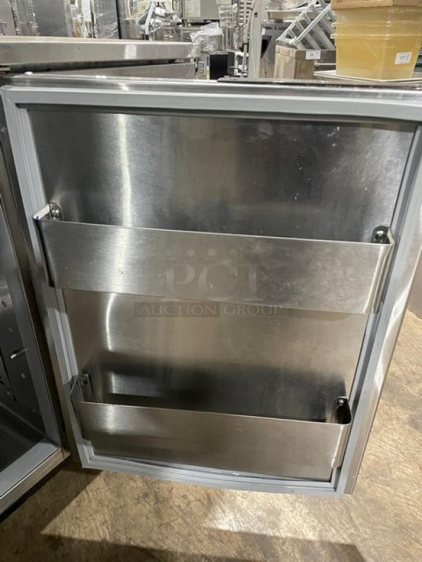 Duke RBC60M stainless steel worktop refrigerator with upturned backsplash, 2 doors, 60", model tags visible, on legs.