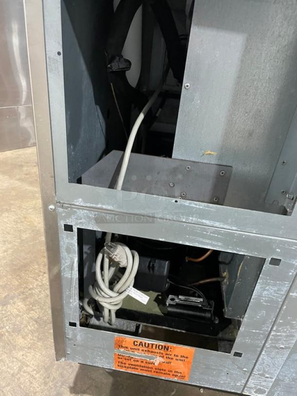 Duke Commercial stainless steel 2-door worktop refrigerator, Model RBC60M; visible wiring and caution label.