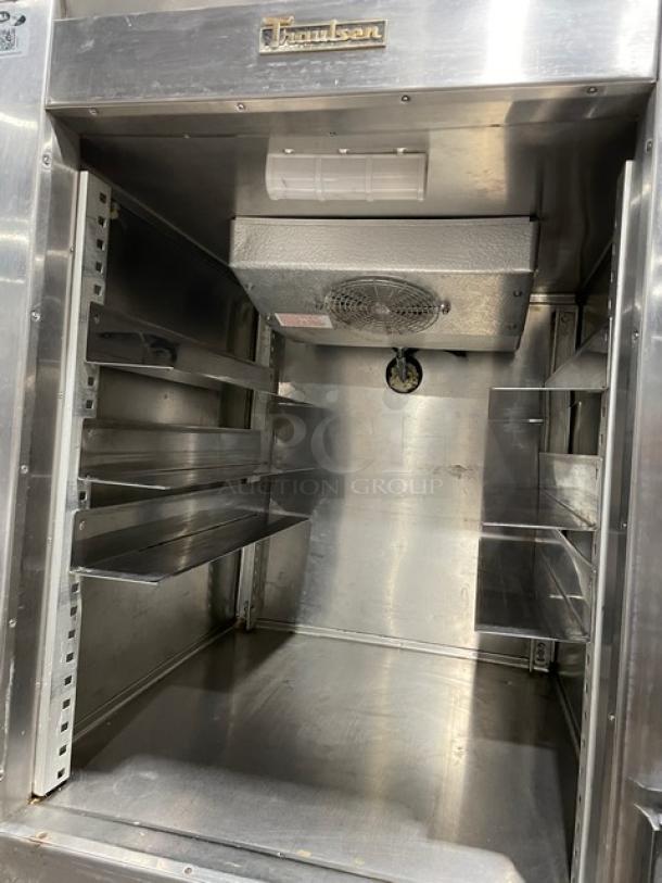 Traulsen RDT132WUT stainless steel reach-in refrigerator/freezer combo, interior view with pan slide and wiring slots, on legs.