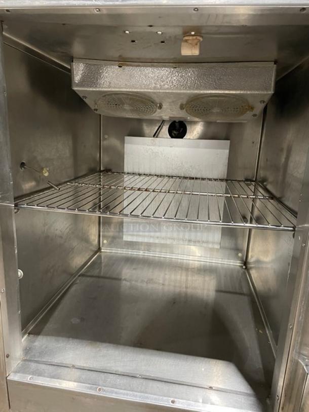 Traulsen stainless steel reach-in refrigerator/freezer combo, Model RDT132WUT, with pan slide, chrome rack, on legs.
