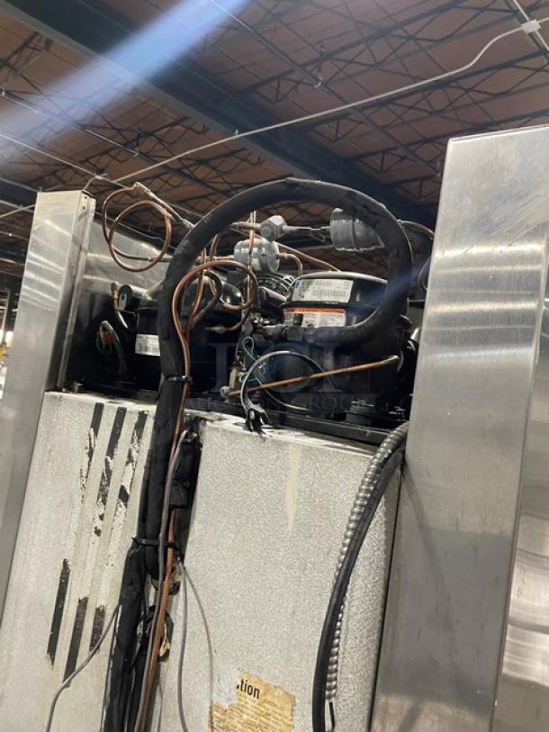 Traulsen commercial stainless steel refrigerator/freezer, Model RDT1-32WUT, with built-in pan slide, chrome rack, and visible wiring.