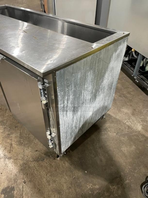 Leader commercial stainless steel refrigerated prep table, 2-1/2 doors with poly coated wire rack, 115V 1 Phase, on casters.