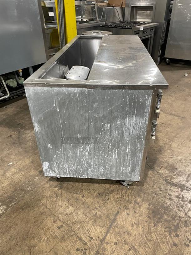 Leader commercial stainless steel prep table with 2.5 doors, poly coated wired rack, on casters, visible wear, 115V 1-phase.