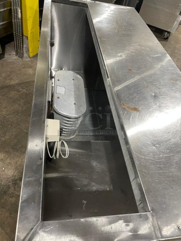 Leader Commercial Stainless Steel 2-1/2 Door Refrigerated Prep Table, includes poly-coated wire rack, 115V, on casters, used condition.