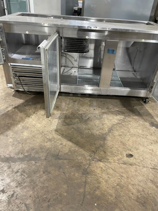 Leader stainless steel 2-1/2 door refrigerated prep table with poly coated rack, 115V 1 Phase, on casters, open door view.