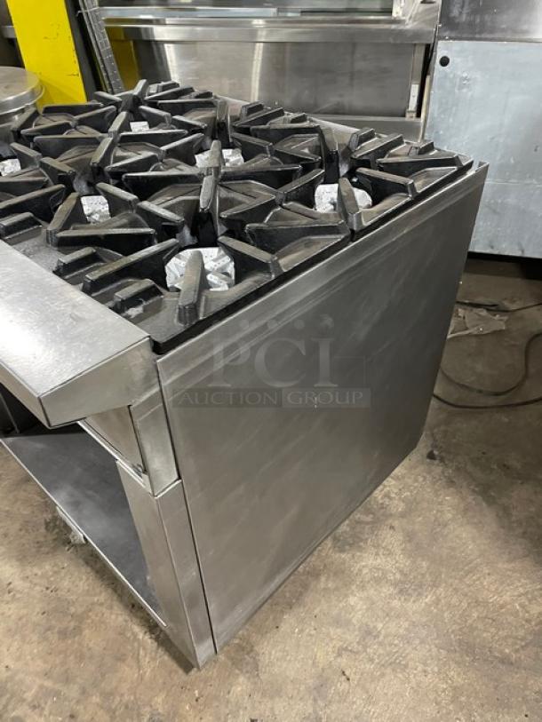 U.S. Range stainless steel 6-burner natural gas range with enclosed cabinet base on casters; commercial-grade condition.