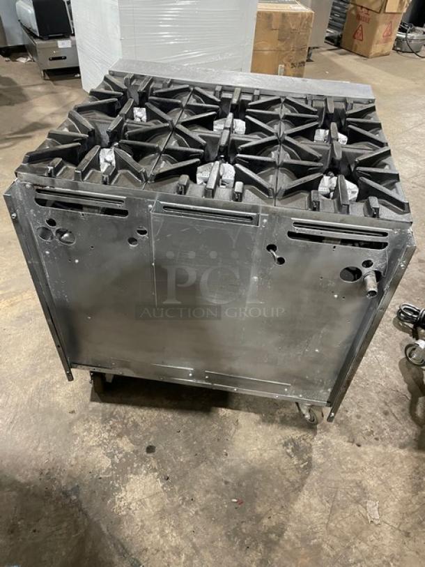 U.S. Range stainless steel 6-burner gas range with enclosed cabinet base. Features durable construction, on casters for mobility.