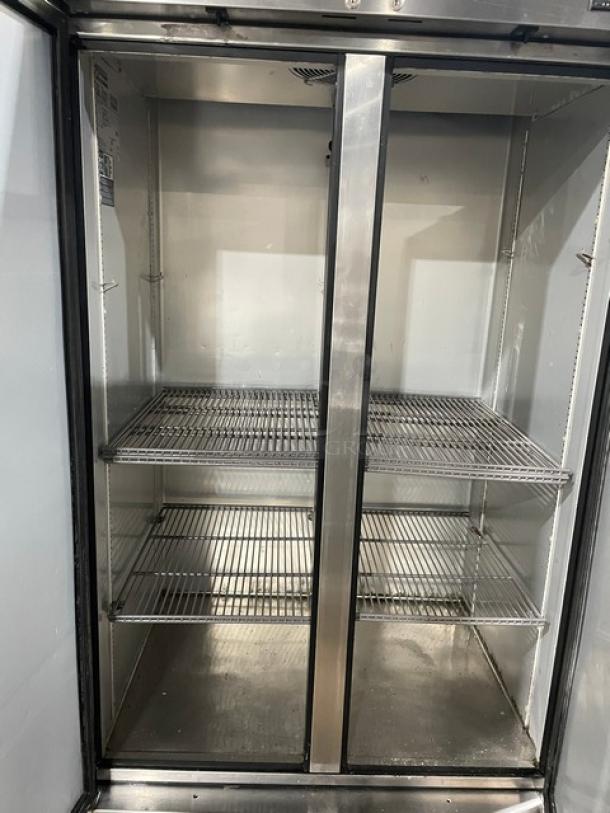 True T-35-HC commercial 2-door stainless steel refrigerator with poly-coated racks, in good condition, on casters.