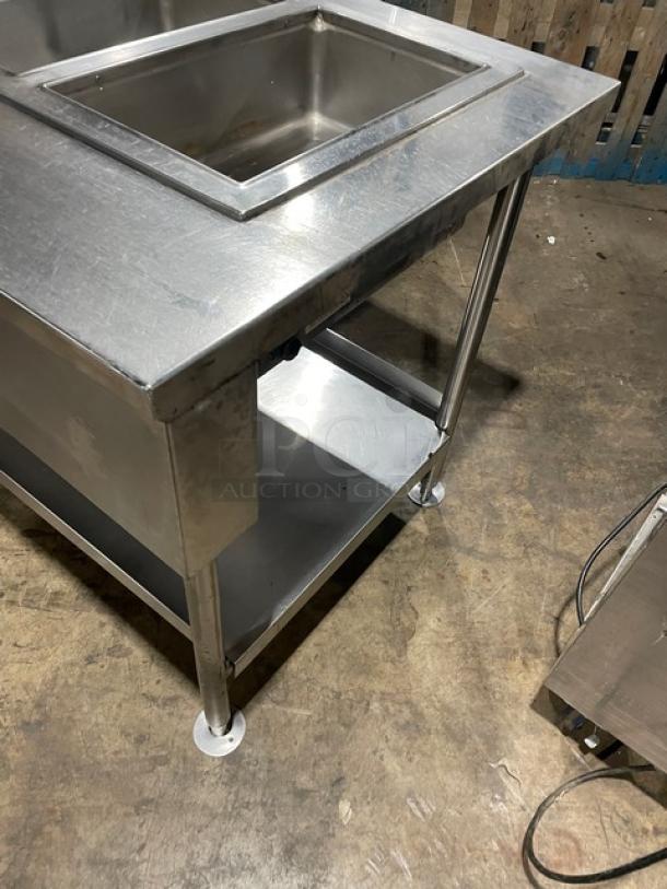 Wells MOD300TDM stainless steel 3-well steam table with single undershelf, electric-powered, on legs, 208/240V.