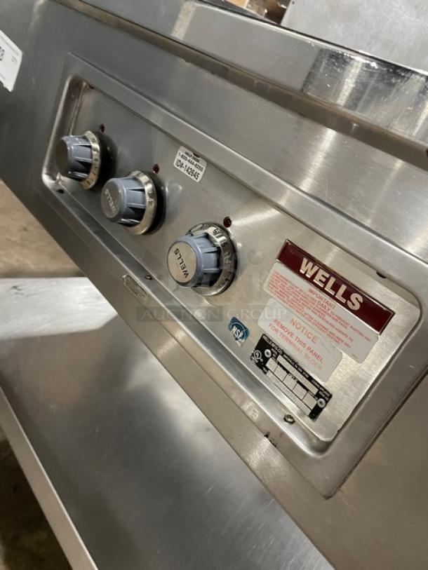 Wells MOD300TDM stainless steel electric steamtable with three wells, single undershelf, and control knobs; 208/240V.