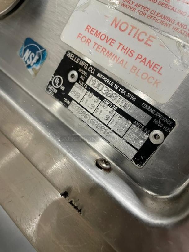 Wells MOD300TDM stainless steel 3-well steam table. Features: single undershelf, model and power info visible.