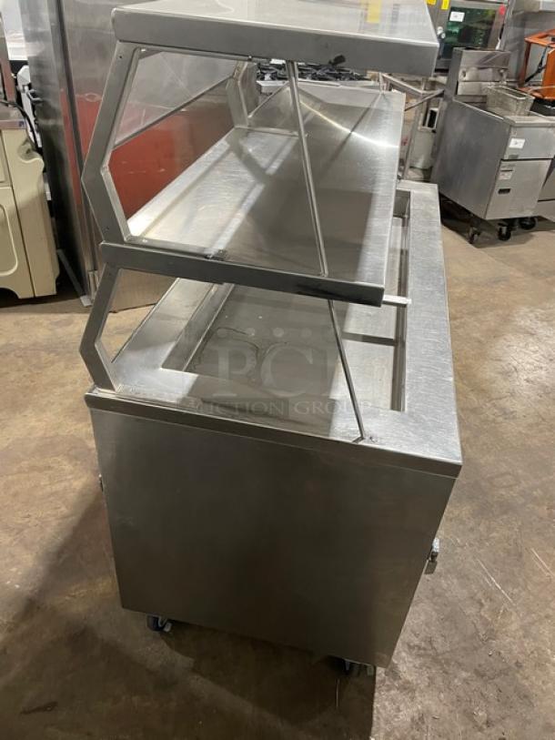 Precision SST2024RTNYC refrigerated salad bar with double sneeze guard and enclosed shelf base on casters. Stainless steel.