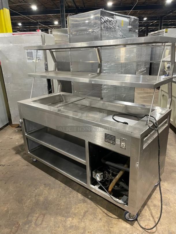 Precision SST2024RTNYC refrigerated salad bar, stainless steel, double overhead shelf, sneeze guard, enclosed base, on casters.
