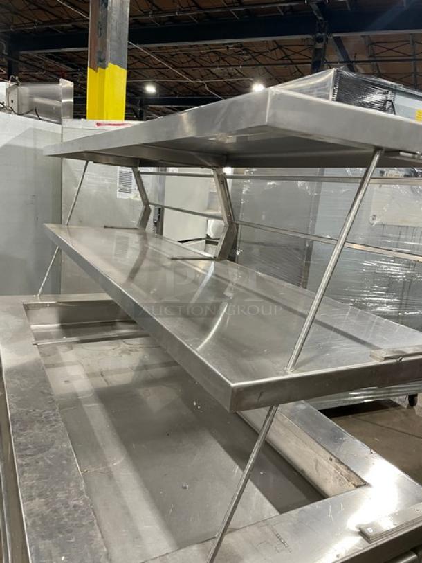 Precision SST2024RTNYC stainless steel salad bar with double overhead shelf, sneeze guard, and cabinet base on casters.