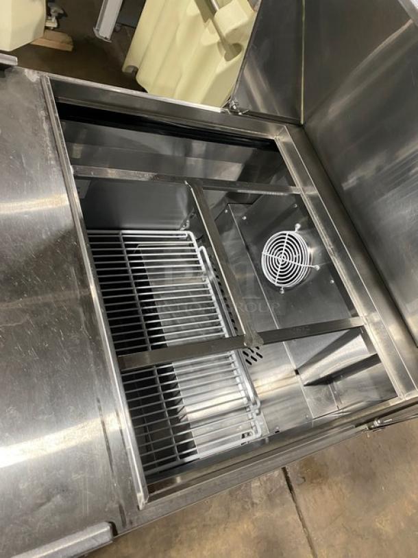 Atosa stainless steel single door refrigerated prep table, bain marie style, with poly-coated wire rack, 115V, on casters.