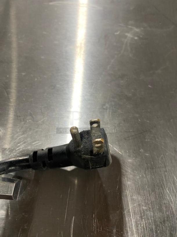 Close-up of a 115V plug from an Atosa refrigerated prep table, emphasizing electrical compatibility.