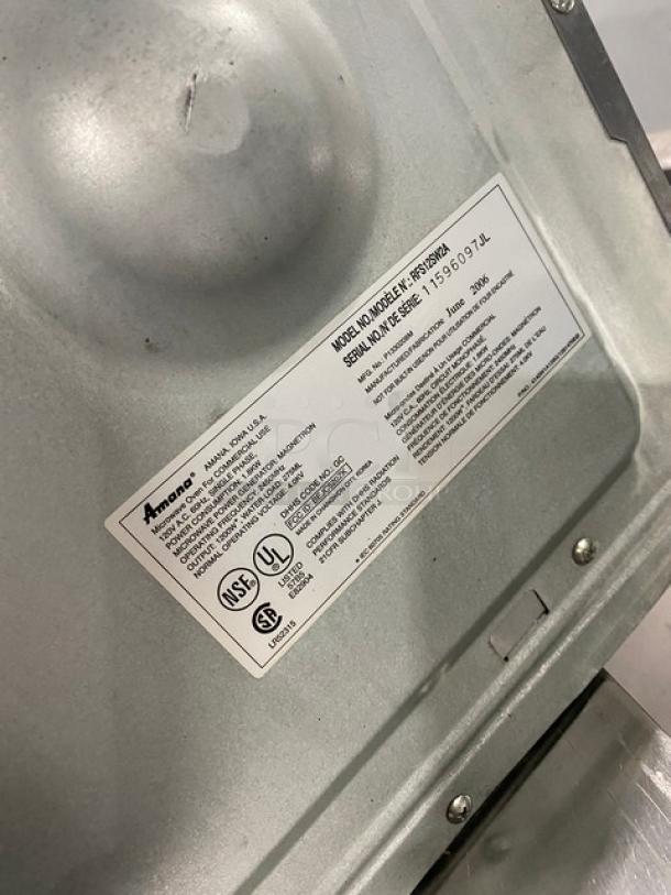 Amana commercial stainless steel microwave, model RFS12SW2A, shown with manufacturer's label displaying specifications.
