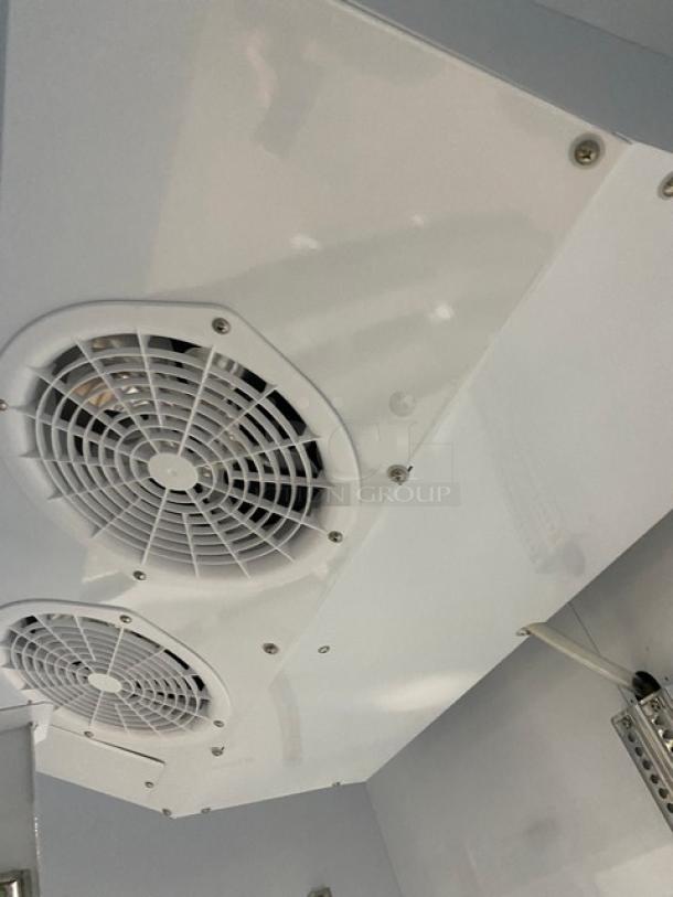 Turbo Air TGM-47SDW commercial refrigerator's interior, featuring dual cooling fans. Energy Star certified.