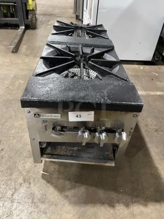 Cookline stainless steel gas double burner stock pot range, on legs, with control knobs and brand label visible.