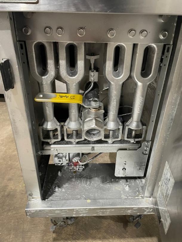 Pitco 40DSM commercial stainless steel natural gas deep fat fryer with backsplash, basket hanger, on casters, exposed internals.