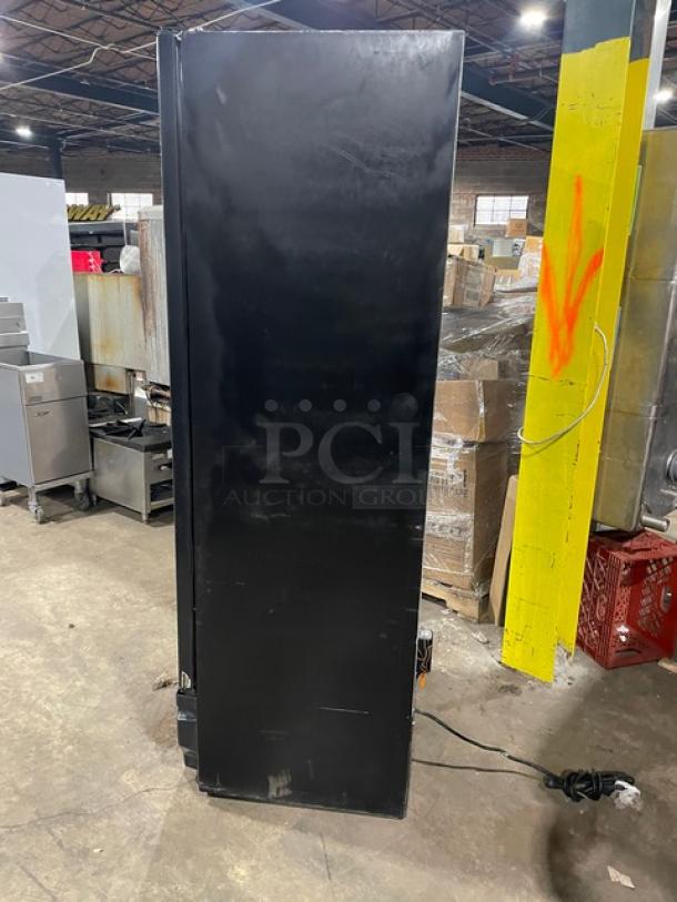 Imbera Elite Series G319 commercial black reach-in merchandiser refrigerator, single glass swing door, on legs, with poly-coated wired rack, 115V, Energy Star certified.