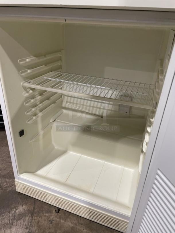 Fisher Scientific undercounter flammable materials storage unit, model 979381, white, with poly coated wire rack, 120V, 1 phase.