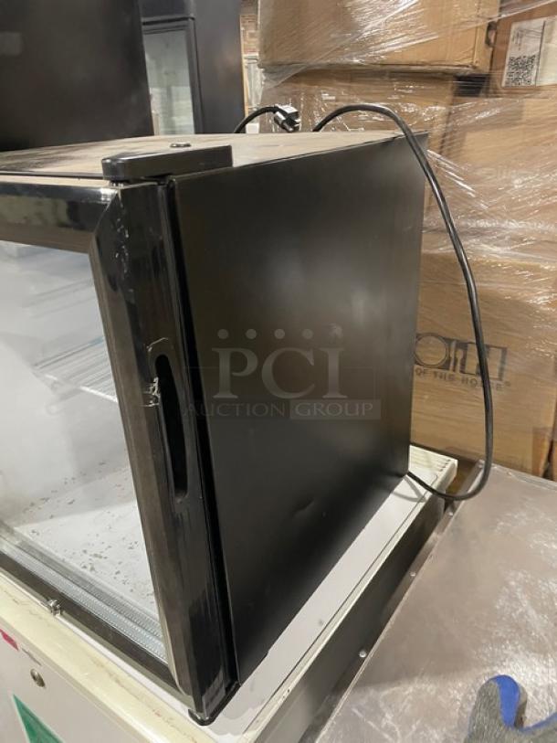 Nordon SC52 commercial black countertop merchandiser refrigerator. Single glass door, poly coated wired rack, 120V.