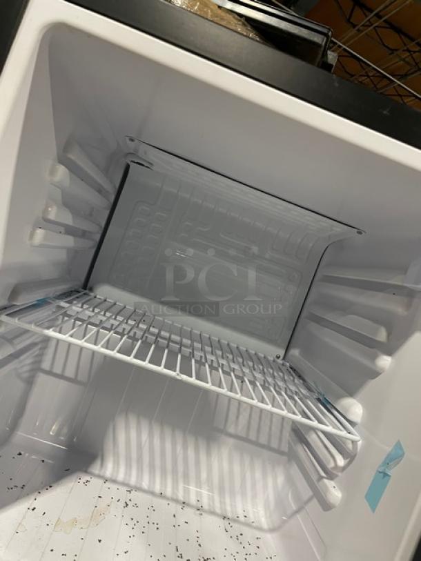 Nordon SC52 black countertop merchandiser refrigerator, single glass door, poly coated wire rack, 120V, excellent condition.