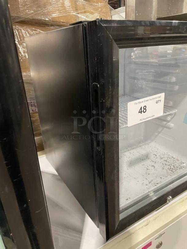 Nordon SC52 black countertop merchandiser refrigerator, single glass door, poly coated wired rack, 120V, good condition.