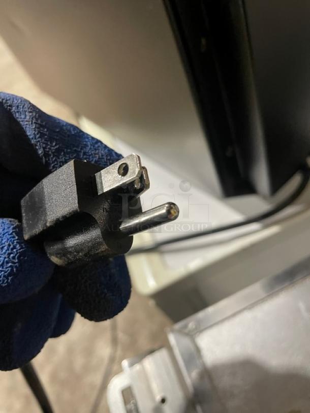 Nordon SC52 countertop merchandiser refrigerator's plug, black, 120V, with a close-up view of electrical prongs.
