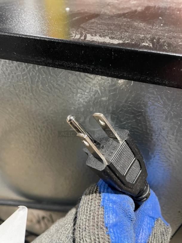 Schmecke commercial 12-bottle wine cooler with black single glass door, chrome plated rack, 115V power cord shown.