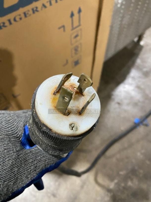 Biro commercial stainless steel electric meat mixer/grinder on casters, plug shown close-up, indicating power requirement.