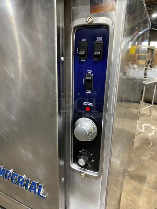 Imperial PCVG1 stainless steel natural gas convection oven, with wired rack, on casters. Control panel with temperature dials.