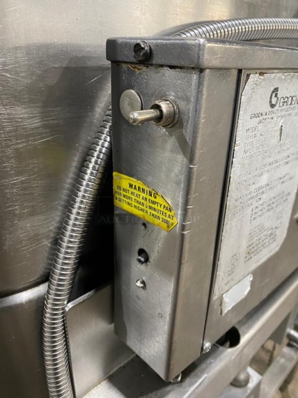 Groen NHFPE4 commercial stainless steel 40-gallon tilt skillet with single spout faucet, on legs. Warning label visible.