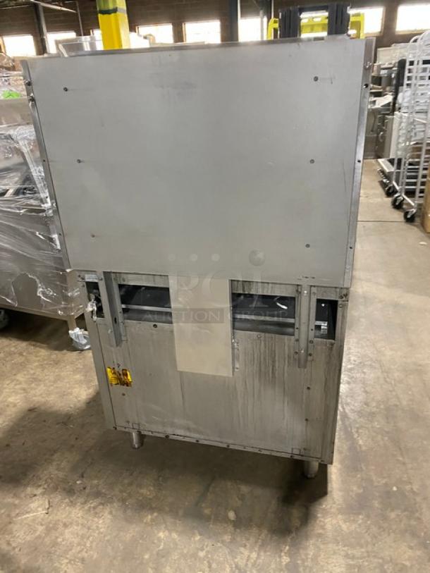 Qualite commercial stainless steel 6-burner gas range/oven combo, with backsplash, overhead salamander shelf, and wired oven rack, on legs.