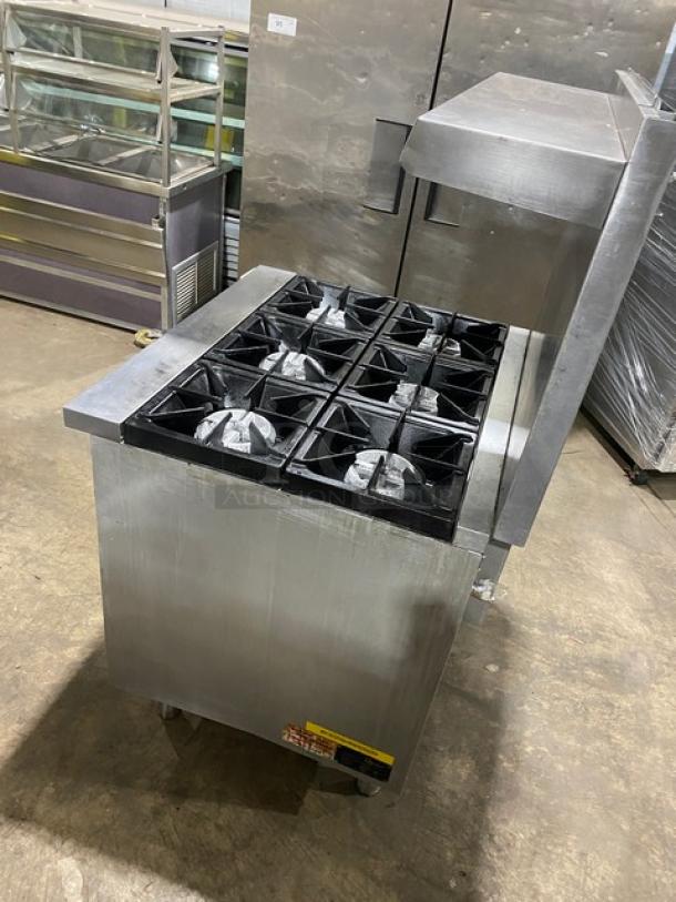 Qualite commercial stainless steel 6-burner gas range/oven combo, features backsplash, overhead salamander shelf, wired oven rack, on legs.