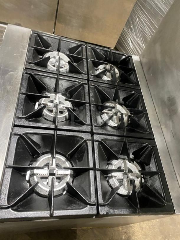 Qualite commercial stainless steel 6-burner gas range/oven, with backsplash, overhead salamander shelf, and wired oven rack.