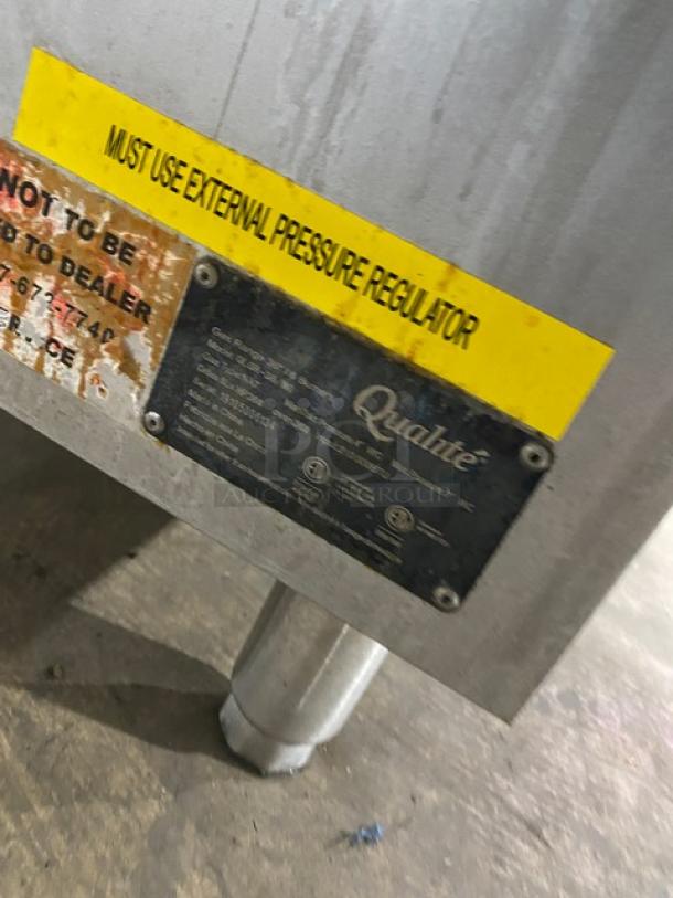 Qualite stainless steel gas 6-burner range/oven combo with backsplash, overhead salamander shelf, wired oven rack, on legs.