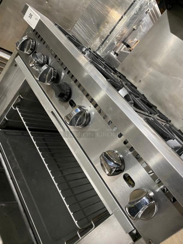 Qualite commercial stainless steel 6-burner range with oven, backsplash, overhead salamander shelf, and wired rack. In good condition.
