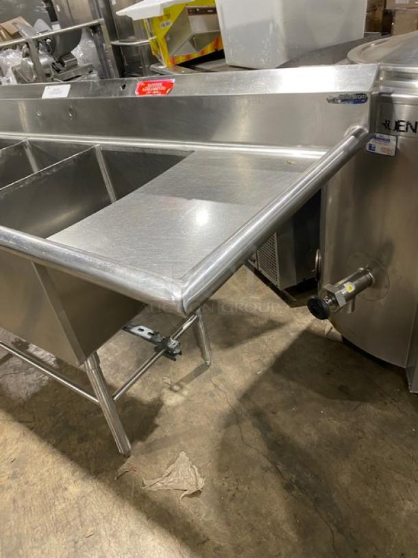 Wasserstrom commercial stainless steel 3-compartment dishwashing sink with left and right drain boards, on legs.