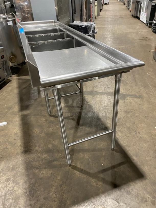 Wasserstrom stainless steel 3-compartment dish washing sink with left and right drain boards, mounted on legs.