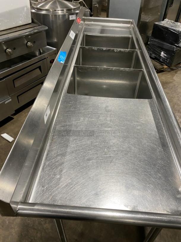 Wasserstrom commercial 3-compartment stainless steel sink with left/right drain boards; on legs, visible minor surface wear.